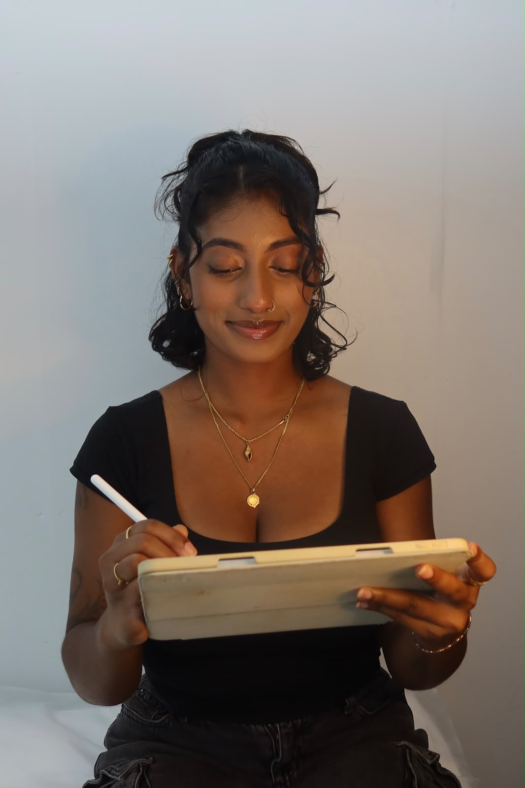 Mathusha sketching a tattoo design on her tablet